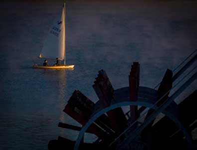 Tom and Willard sail the 2263 Banshee by the Mike Fink Restaurant at first light, photo by Michael Keating